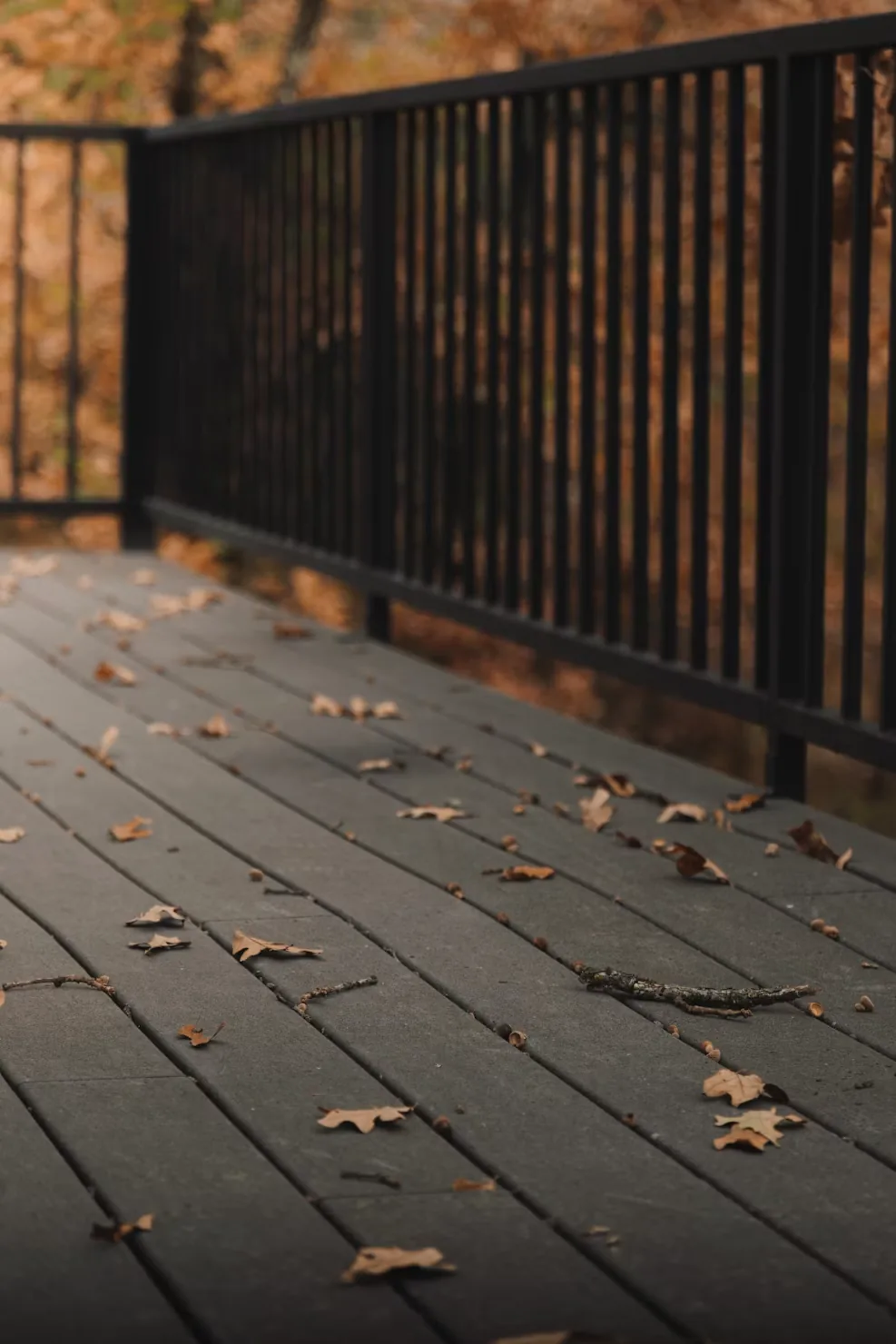 A finished light-wood deck with built-in bench seating